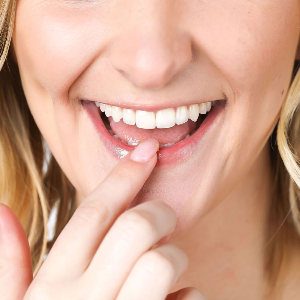 Woman Applying Lique Lip Butter on Lips